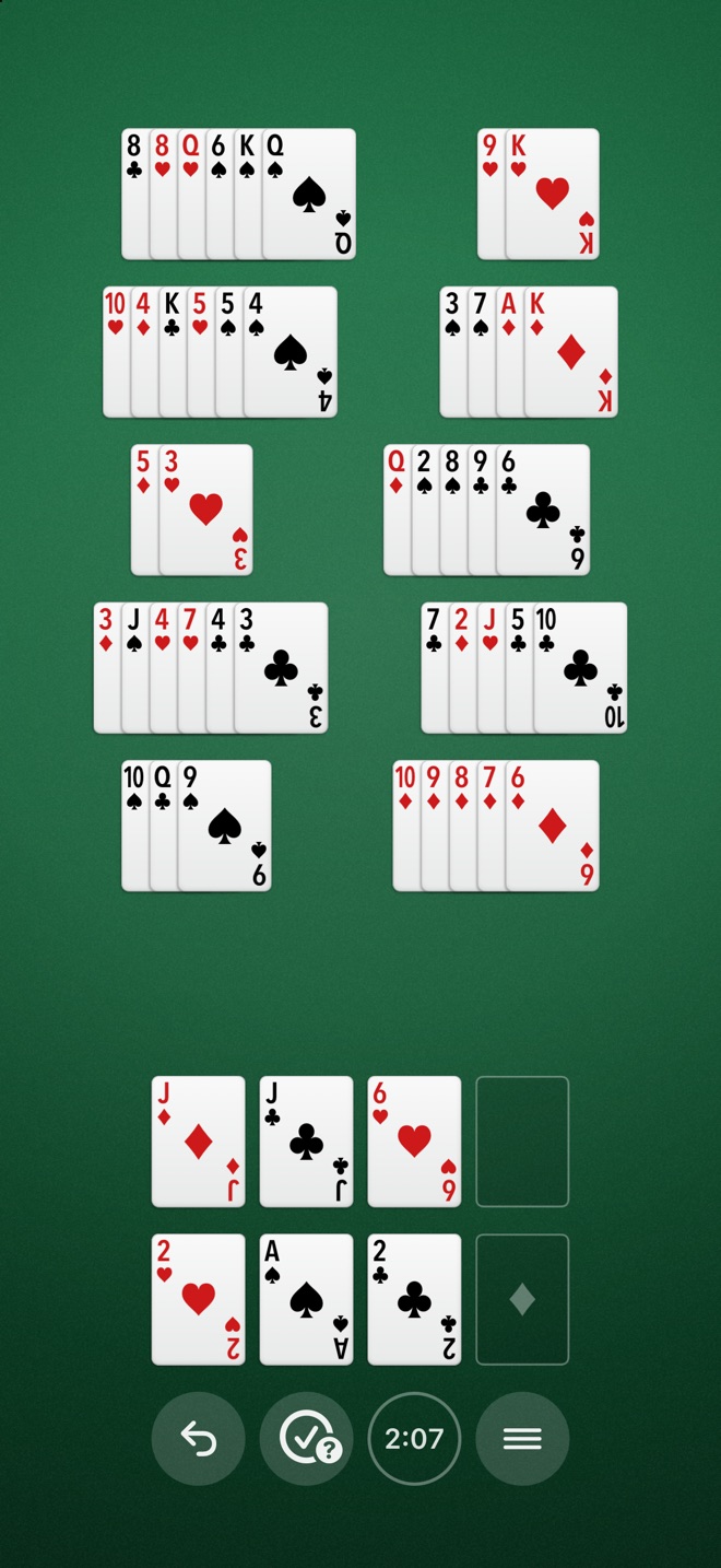A game on an iPhone held upright: the stacks fill the screen, with the free cells, foundations, and four round buttons below them